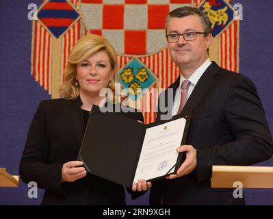 (151223) -- ZAGABRIA, 23 dicembre 2015 -- il presidente croato Kolinda Grabar-Kitarovic (L) conferisce il mandato di formare il nuovo governo al primo ministro croato designato Tihomir Oreskovic durante una cerimonia di presentazione della firma presso l'Ufficio presidenziale di Zagabria, capitale della Croazia, 23 dicembre 2015. Il presidente croato Kolinda Grabar-Kitarovic ha nominato mercoledì sera Tihomir Oreskovic, un non partigiano, come primo ministro designato per formare il prossimo governo dopo 6 settimane di consultazioni con i partiti politici. ) CROAZIA-ZAGABRIA-PRIMO MINISTRO DESIGNATO MisoxLisanin PUBLICATIONxNOTxINxCHN 151223 Foto Stock