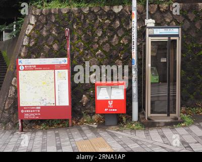 TOKYO, GIAPPONE - 1 agosto 2023: Una strada nel quartiere Taito di Tokyo con cabina telefonica. casella postale e mappa dell'area. Foto Stock