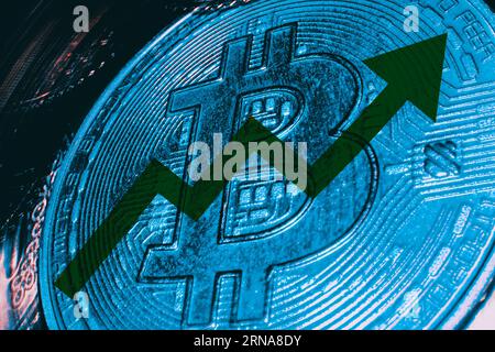 Green arrows up Bitcoin value rising up ( BTC ) prices grow up Concept . Macro view of golden coin. Stock Photo