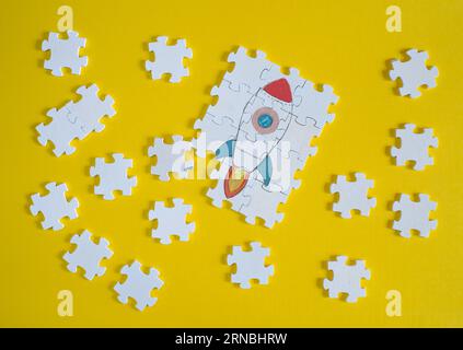 Business concept,idea,innovation,recruitment,human resources,start up.Rocket ship and jigsaw puzzle pieces Stock Photo