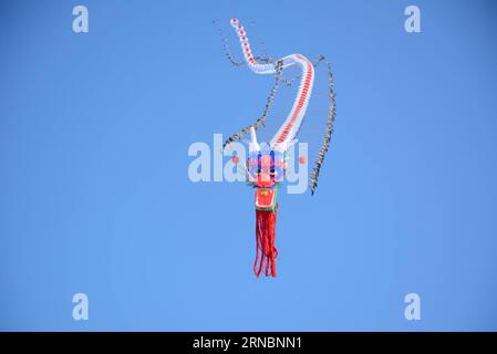 (160310) -- JILIN, March 10, 2016 -- Photo taken on March 10, 2016 shows a flying kite shaped of a dragon of 50 meters in length during a kite-flying show celebrating Chinese Longtaitou Festival at Renmin Square of Jilin City, northeast China s Jilin Province. The Longtaitou Festival, or Eryueer Festival, which means dragon raises head in Chinese, is a traditional Chinese festival held on the second day of the second month in the Chinese lunar calendar. ) (wyl) CHINA-JILIN-LONGTAITOU FESTIVAL-KITE SHOW (CN) WangxMingming PUBLICATIONxNOTxINxCHN   160310 Jilin March 10 2016 Photo Taken ON March Stock Photo