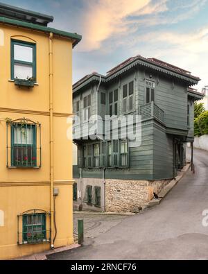 Facciata di colorati edifici residenziali in legno dipinti in verde e giallo e finestre con persiane in legno, in un vicolo adatto nel quartiere Kuzguncuk, nel quartiere Uskudar, a Istanbul, in Turchia Foto Stock