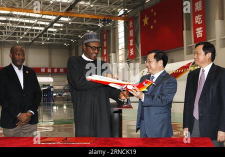 (160414) -- SHANGHAI, April 14, 2016 -- Nigerian President Muhammadu Buhari (2nd L) receives a model of China s domestic regional jet ARJ21 as a gift in east China s Shanghai, April 14, 2016. Buhari, who is on a state visit to China, visited Shanghai Aircraft Design and Research Institute of Commercial Aircraft Corporation of China, Ltd. (COMAC) here Thursday. )(wjq) CHINA-SHANGHAI-NIGERIAN PRESIDENT-COMAC-VISIT (CN) FangxZhe PUBLICATIONxNOTxINxCHN   160414 Shanghai April 14 2016 Nigerian President Muhammadu Buhari 2nd l receives a Model of China S Domestic Regional Jet ARJ21 As a Poison in Ea Stock Photo