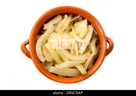 Affettare il finocchio in una ciotola di argilla Foto Stock