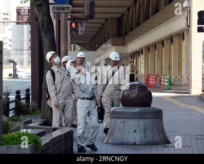 (160417) -- KUMAMOTO, April 17, 2016 -- Technicians check the buildings at the city center in the earthquake rocked Kumamoto prefecture, Japan, April 17, 2016. A powerful magnitude-7.3 earthquake struck the island of Kyushu in southwestern Japan early Saturday just a day after a sizable foreshock hit the region, with the number of fatalities now standing at 41 according to the latest figures on Sunday. ) (djj) JAPAN-KUMAMOTO-EARTHQUAKE-AFTERMATH MaxPing PUBLICATIONxNOTxINxCHN   160417 Kumamoto April 17 2016 Technicians Check The Buildings AT The City Center in The Earthquake Rocked Kumamoto Pr Stock Photo