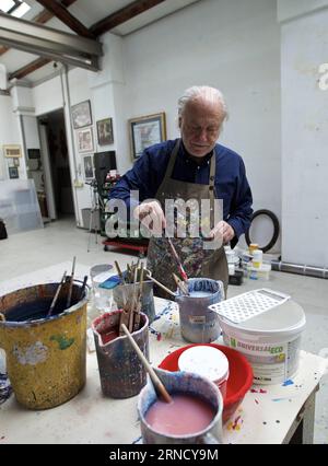 Umberto Mariani Fotostory (160425) -- MILAN, April 25, 2016 -- Mariani prepares to paint the fold made of lead sheet at his studio in Milan, Italy, on April 13, 2016. Italian artist Umberto Mariani lives and works at a loft in a former factory in Milan. Mariani, who will turn 80 at the end of this year, is best known for his multidimensional folds of fabric carved out of lead sheets. During the 1960s, Mariani picked up his first projects doing monumental narrative work for the St. Peter s Basilica in Vatican City as well as mosaics and frescos, but the classical Greek statues that he grew up o Stock Photo