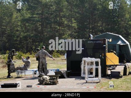 (160428) -- RIGA, April 28, 2016 -- German soldiers disinfect Latvian soldiers during the Operation Summer Shield XIII military exercise held at Adazi Training Area outside Riga, Latvia, April 28, 2016. About 1300 soldiers from Latvia, Lithuania, the United States, Canada, Finland and Germany etc. took part in the military exercise from April 17 to 29. ) LATVIA-RIGA-OPERATION SUMMER SHIELD-EXERCISE GuoxQun PUBLICATIONxNOTxINxCHN   160428 Riga April 28 2016 German Soldiers disinfect Latvian Soldiers during The Operation Summer Shield XIII Military EXERCISE Hero AT Adazi Training Area outside Ri Stock Photo