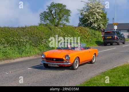 1973 70s seventies Orange Fiat Petrol 1592 cc; en-route to Capesthorne Hall classic car show, Cheshire, UK Stock Photo