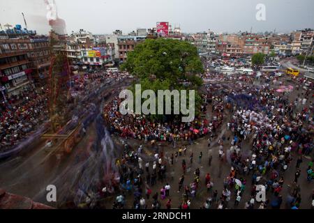 (160516) -- LALITPUR, May 15, 2016 -- Devotees pull the chariot of Rato Macchindranath during Rato Machhindranath festival in Lalitpur, Nepal, May 15, 2016. According to the Hindu legend, Rato Machhindranath is known as the god of rain. The month-long Rato Machhindranath festival begins with the construction of the chariot in Pulchowk and ends with the Bhoto Jatra festival in Jawalakhel of Patan. It is celebrated by Buddhists and Hindus of Newar community by carrying the chariot to different places in the town of Patan in hope for good rain and prosperity. ) (zjy) NEPAL-LALITPUR-RATO MACHHINDR Stock Photo