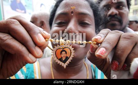 (160520) -- CHENNAI, May 19, 2016 -- A supporter shows a necklace with a portrait of Jayaram Jayalitha as she celebrates the victory of Jayaram Jayalitha and her party All India Anna Dravida Munnetra Kazhagam (AIADMK) in Chennai, capital of southern Indian state Tamil Nadu, May 19, 2016. AIADMK won the assembly election for the 6th time on Thursday. )(zhf) INDIA-CHENNAI-ASSEMBLY ELECTION-AIADMK-CELEBRATION Stringer PUBLICATIONxNOTxINxCHN   160520 Chennai May 19 2016 a Supporter Shows a Necklace With a Portrait of Jayaram  As She celebrates The Victory of Jayaram  and her Party All India Anna D Stock Photo