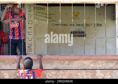 (160531) -- NAIROBI, May 31, 2016 -- Photo taken on May 29, 2016 shows children having a rest after their practices at the Sejorooney Kids Talent Center, at the Mathare slums in Nairobi, Kenya. When the Kenyan duo of Dominic Senerwa and Joseph Mwangi acquired a disused building at the local police post in Mathare slums in Nairobi for philanthropic work, little did they know that their pet project would come to realization. Senerwa, 21, and Mwangi, 23, embarked on their charitable mission to turn around the lives of children from rundown homes within the informal settlement, having grown up in Stock Photo