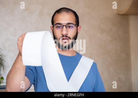 un uomo scioccato dall'ammontare delle bollette che deve pagare Foto Stock