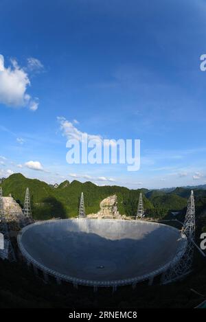 Riesiges Radioteleskop FAST in Pingtang, China (160628) -- GUIZHOU, June 27, 2016 -- Photo taken on June 27, 2016 shows the Five hundred meter Aperture Spherical Telescope, or FAST, at sunset in Pingtang County, southwest China s Guizhou Province. Construction of the world s largest telescope FAST started in March 2011. The telescope will be used to detect and collect signals and data from the universe. ) (wx) CHINA-GUIZHOU-FAST-CONSTRUCTION-SCENERY (CN) LiuxXu PUBLICATIONxNOTxINxCHN   Huge Radio telescope Almost in Ping Tang China 160628 Guizhou June 27 2016 Photo Taken ON June 27 2016 Shows Stock Photo