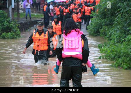 (160702) -- ANQING, July 2, 2016 -- Rescuers evacuate a little girl in Shouquan Village of Huaining County, east China s Anhui Province, July 2, 2016. Due to heavy rainfall, rescuers were sent to Shouquan Village to evacuate more than 60 villagers trapped in flood early Saturday morning. The National Meteorological Center (NMC) and the Ministry of Water Resources warned of high risks of mountain torrents in parts of Anhui, Hunan, Guizhou and Tibet from Friday evening to Saturday evening, suggesting residents take necessary precautions. ) (wx) CHINA-ANHUI-HEAVY RAIN (CN ) WangxTianxiang PUBLICA Stock Photo