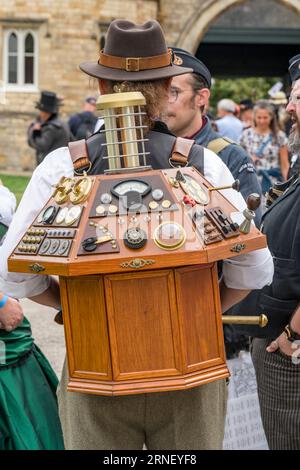 Uomo che trasporta un modello di pannello di controllo della macchina del tempo al Lincoln Steampunk weekend 2023, Lincoln City, Lincolnshire, Inghilterra, Regno Unito Foto Stock