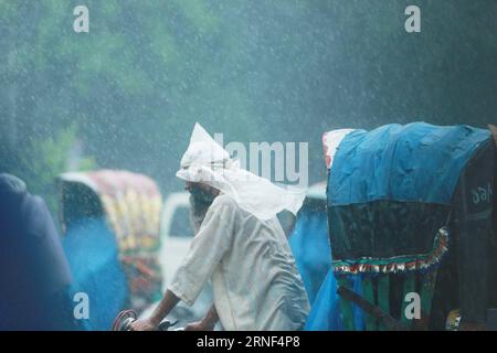 (160718) -- DHAKA, July 18, 2016 -- A rickshaw puller carries passengers in the rain in Dhaka, Bangladesh, on July 18, 2016. )(zhf) BANGLADESH-DHAKA-RAIN SharifulxIslam PUBLICATIONxNOTxINxCHN   160718 Dhaka July 18 2016 a rickshaw Puller carries Passengers in The Rain in Dhaka Bangladesh ON July 18 2016 zhf Bangladesh Dhaka Rain SharifulxIslam PUBLICATIONxNOTxINxCHN Stock Photo