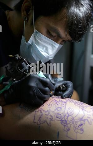 (160812) -- PASAY CITY, 12 agosto 2016 -- un artista tatua un cliente durante l'annuale Philippine Tattoo Expo a Pasay City, Filippine, 12 agosto 2016. Il Philippine Tattoo Expo è un evento annuale in cui acclamati artisti e appassionati di tatuaggio si riuniscono per assistere e partecipare a competizioni di tatuaggio. (Zjy) FILIPPINE-PASAY CITY-TATTOO EXPO RouellexUmali PUBLICATIONxNOTxINxCHN 160812 Pasay City 12 agosto 2016 a Artist Tattoos a Customer durante l'Annual Philippine Tattoo EXPO a Pasay City, Filippine 12 agosto 2016 l'EXPO Philippine Tattoo EXPO SI terrà all'evento annuale dove acclamato tatto Foto Stock