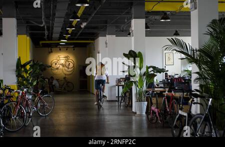 BEIJING,, 2016 -- Founder of 700BIKE Zhang Xiangdong rides his bicycle in the office of 700BIKE in Beijing, capital of China, Aug. 10, 2016. As a big fan of bicycle, Zhang Xiangdong co-founded the 700BIKE to provide bicycles with exquisite design for the urban dwellers. This young entrepreneurial startup aims to promote bicycle culture and is committed to building a lifestyle and sports aesthetics among the consumers. )(wsw) CHINA-BEIJING-LIFESTYLE-BICYCLE (CN) LyuxShuai PUBLICATIONxNOTxINxCHN   Beijing 2016 Founder of  Zhang Xiang Dong Rides His BICYCLE in The Office of  in Beijing Capital of Stock Photo