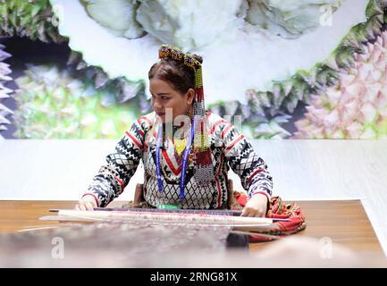 (160911) -- NANNING, Sept. 11, 2016 -- A women of the Philippines performs weaving at the 13th China-ASEAN Expo in Nanning, capital of south China s Guangxi Zhuang Autonomous Region, Sept. 11, 2016. )(wyl) CHINA-GUANGXI-ASEAN-EXPO (CN) ChengxLi PUBLICATIONxNOTxINxCHN   160911 Nanning Sept 11 2016 a Women of The Philippines performs Weaving AT The 13th China Asean EXPO in Nanning Capital of South China S Guangxi Zhuang Autonomous Region Sept 11 2016 wyl China Guangxi Asean EXPO CN ChengxLi PUBLICATIONxNOTxINxCHN Stock Photo