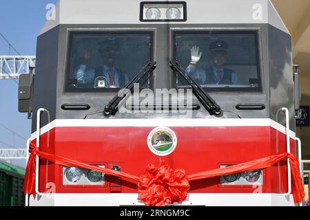 neue Eisenbahnstrecke zwischen der Hauptstadt Addis Abeba und Dschibuti (161006) -- ADDIS ABABA, Oct. 6, 2016 -- Chinese train driver Liu Ji (R) and his Ethiopian colleague Geto wave hands before the start of the first passenger train of the Addis Ababa-Djibouti railway in Addis Ababa, Ethiopia, on Oct. 5, 2016. Ethiopia and Djibouti on Wednesday launched Africa s first modern electrified railway connecting their capitals, with officials hailing the Chinese-built rail as the latest testament to the Sino-African friendship. The 752.7-km Ethiopia-Djibouti railway, also known as Addis Ababa-Djibo Stock Photo