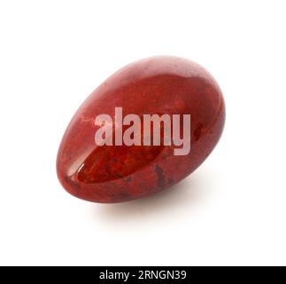 Red jasper stone in shape of egg isolated on white background Foto Stock