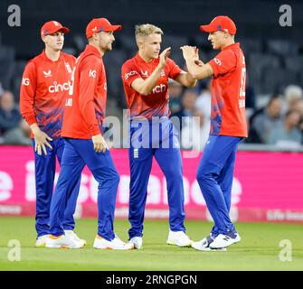 Old Trafford, Manchester, UK. 1st Sep, 2023. 2nd IT20, England versus New Zealand; Sam Curran of England (second from right) is congratulated by team mates after taking the wicket of Finn Allen of New Zealand for 3 caught Will Jacks of England Credit: Action Plus Sports/Alamy Live News Stock Photo