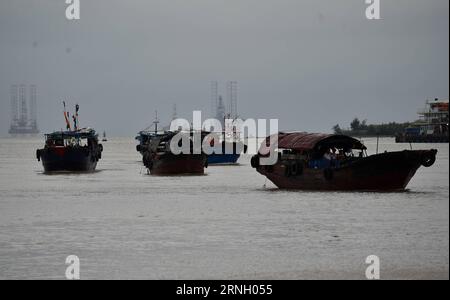 (161019) -- HAIKOU, Oct. 19, 2016 -- Fishing boats leave a shelter harbor after typhoon Sarika in Haikou, capital of south china s Hainan Province, Oct. 19, 2016. Local meteorological bureau of Hainan has removed the third level rainstorm alarm on Wednesday morning. The 21st typhoon of the year Sarika has entered the sea area of Beibu Gulf and is likely to make landfall again at the border area between Vietnam and China. ) (wx) CHINA-HAIKOU-TYPHOON SARIKA (CN) ZhaoxYingquan PUBLICATIONxNOTxINxCHN   Haikou OCT 19 2016 Fishing Boats Leave a Shelter Harbor After Typhoon Sarika in Haikou Capital o Stock Photo