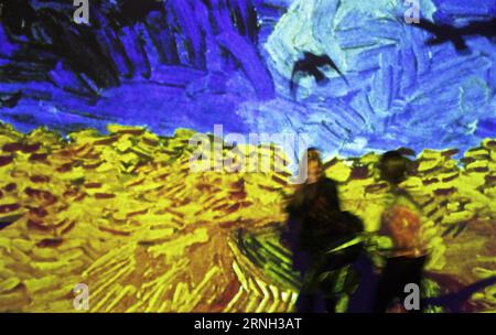 ROME, Oct. 25, 2016 -- Two women walk past the image of the painting Wheat Field with Crows at the Van Gogh Alive exhibition in Rome, Italy, Oct. 25, 2016. The exhibition kicked off on Monday and will last until March 26, 2017. With 3,000 images, of which more than 800 paintings of Vincent van Gogh come alive, the exhibition shows the life and artworks of Vincent van Gogh in 1880-1890 with the innovative video technology. ) (gl) ITALY-ROME- VAN GOGH ALIVE EXHIBITION JinxYu PUBLICATIONxNOTxINxCHN   Rome OCT 25 2016 Two Women Walk Past The Image of The Painting Wheat Field With Crows AT The van Foto Stock