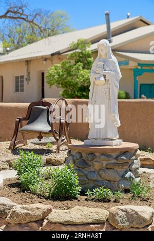 Statua di Santa chiara in plaza di fronte alla chiesa missionaria cattolica di San Francisco de Asis a Taos, New Mexico Foto Stock