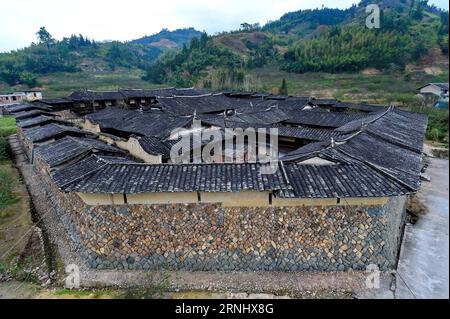 (161216) -- FUZHOU, Dec. 15, 2016 -- Photo taken on Dec. 15, 2016 shows the Zhongpu Stockaded Village at Changqing Township in Yongtai County, southeast China s Fujian Province. Built during the Jiaqing Emperor regime of Qing Dynasty (1760-1820), Zhongpu Stockaded Village is a courtyard building made of earth and wood, covering an area of 10,000 square metres with a total of 182 rooms. The stockaded village has be preserved for over 200 years and passed to the 10th generation of residents at present.) (yxb) CHINA-FUJIAN-STOCKADED VILLAGE(CN) ZhangxGuojun PUBLICATIONxNOTxINxCHN   Fuzhou DEC 15 Stock Photo