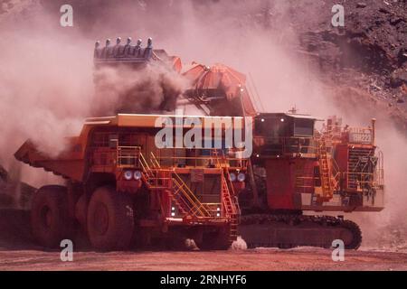 (161220) -- SYDNEY, Dec. 20, 2016 -- A digger unloads waste material to a dump truck at Rio Tinto Ltd. s Paraburdoo mine in Pilbara region, Australia, Dec. 14, 2016. Rio Tinto is currently in negotiations with steel makers Baosteel Group and Shougang Group over a new pricing mechanism for its Australian ore, however the key customers haven t yet agreed to the terms. Rio Tinto s seeking of a new pricing mechanism for its iron ore with Chinese customers is justified given the dramatic lift in coking coal prices, chief executive Jean-Sebastian Jacques believes. )(zcc) AUSTRALIA-RIO TINTO LTD.-OPE Stock Photo