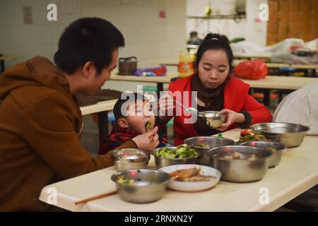 (180206) -- SHISHI, 6 febbraio 2018 -- Huang Hailong ha una cena di riunione con la moglie e il figlio più giovane a Shishi City, provincia del Fujian nel sud-est della Cina, 1 febbraio 2018. Huang Hailong, un lavoratore migrante proveniente dalla città suinosa della provincia del Sichuan della Cina sud-occidentale, ha lavorato in una fabbrica di abbigliamento a Shishi per dieci anni. Sebbene visse con la moglie e il figlio minore Cong, a Huang mancano ancora i suoi genitori e il figlio maggiore che vivono nella zona montuosa del Sichuan. Quest'anno, per risparmiare, Huang decise di tornare da solo nella sua città natale per trascorrere il Festival di Primavera con le sue famiglie nel Sichuan. Foto Stock