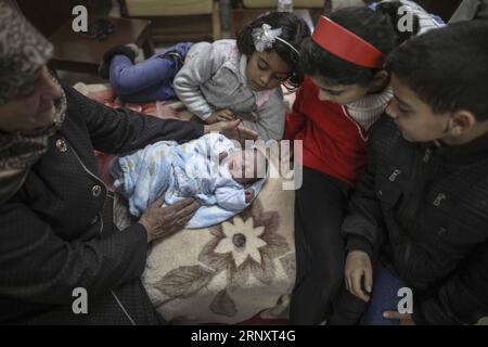 (180211) -- GAZA, 11 febbraio 2018 -- i membri di una famiglia palestinese tendono un neonato all'interno di un ospedale nella città di Gaza, l'11 febbraio 2018. Il bambino di prova, chiamato Mujahid, è nato con lo sperma di contrabbando di suo padre condannato per sette anni nella prigione israeliana. Molte donne palestinesi con mariti che prestano servizio a lungo termine nelle carceri israeliane hanno fatto ricorso a furtivare spermatozoi e rimanere incinte. ) MIDEAST-GAZA-CONTRABBANDO DI SPERMATOZOI WissamxNassar PUBLICATIONxNOTxINxCHN Foto Stock