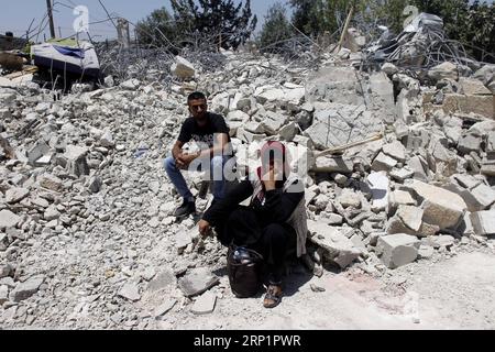 (180719) -- GERUSALEMME, 19 luglio 2018 -- i palestinesi siedono tra le rovine di case nel quartiere di Gerusalemme Est di Beit Hanina, 19 luglio 2018. I residenti palestinesi hanno demolito le loro abitazioni per non affrontare la prospettiva che i coloni israeliani si trasferiscano dopo aver perso un caso di proprietà terriera nei tribunali israeliani. ) MIDEAST-GERUSALEMME-PALESTINA DWELLING-DEMOLISHMENT MuammarxAwad PUBLICATIONxNOTxINxCHN Foto Stock