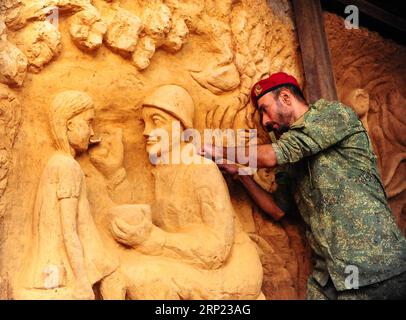 (180815) -- DAMASCO, 15 agosto 2018 -- Un soldato siriano lavora per perfezionare una scultura sul muro di un tunnel sotterraneo precedentemente gestito dai ribelli nel quartiere di Jobar, nella campagna orientale di Ghouta, nella capitale Damasco, il 14 agosto 2018. Gli artisti siriani hanno trasformato i tunnel in una galleria di sculture dopo la sconfitta dei ribelli a Ghouta orientale lo scorso aprile. )(gj) SYRIA-DAMASCO-MILITANT TUNNELS-SCULTPURE GALLARY AmmarxSafarjalani PUBLICATIONxNOTxINxCHN Foto Stock