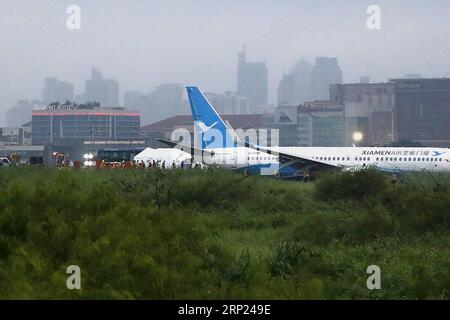 (180817) -- MANILA, 17 agosto 2018 -- il personale di emergenza risponde al Boeing 737-800 di Xiamen Airlines nell'area di sicurezza erba dopo aver deviato all'atterraggio all'aeroporto internazionale Ninoy Aquino (NAIA) a Paranaque City, Filippine, 17 agosto 2018. Un aereo passeggeri della Xiamen Airlines di Cina è sceso dalla pista e si è portato sull'erba quando è atterrato all'aeroporto internazionale di Manila venerdì presto. ) FILIPPINE-MANILA-XIAMEN AEREO-INCIDENTE ROUELLExUMALI PUBLICATIONxNOTxINxCHN Foto Stock