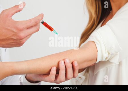 Un medico che prende il sangue Foto Stock