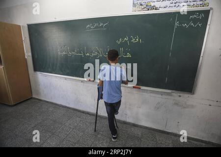 (180904) -- GAZA, 4 settembre 2018 -- Mohammad abu-Hussein, 13 anni, uno studente palestinese rifugiato, scrive sulla lavagna della Jabalia School for Refugees nella Striscia di Gaza settentrionale, il 4 settembre 2018. Il presidente palestinese Mahmoud Abbas ha detto domenica che la questione dei rifugiati palestinesi deve essere risolta in conformità con le legittime risoluzioni internazionali. ) MIDEAST-GAZA-REFUGEE ISSUE WissamxNassar PUBLICATIONxNOTxINxCHN Foto Stock