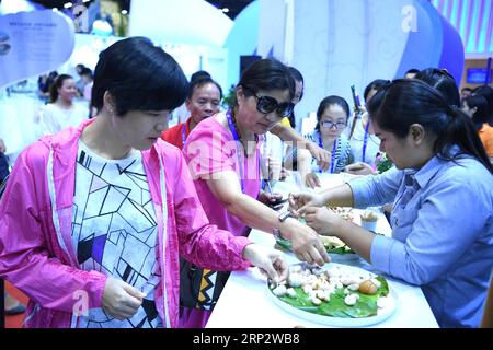 (180912) -- NANNING, 12 settembre 2018 -- People Taste Fruit from Thailand at the Exhibition Hall of the 15th China-ASEAN (Association of Southeast Asian Nations) Expo in Nanning, capitale della regione autonoma del Guangxi Zhuang della Cina meridionale, 12 settembre 2018. L'expo ha aperto qui il mercoledì.) (Zwx) CHINA-NANNING-CHINA-ASEAN EXPO-OPEN (CN) ZhouxHua PUBLICATIONxNOTxINxCHN Foto Stock