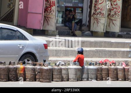 (180918) -- SANAA, 18 settembre 2018 -- Un bambino siede su bombole vuote di gas di cottura su una strada principale a Sanaa, Yemen, il 18 settembre 2018. Le strade sono quasi vuote nella capitale dello Yemen, Sanaa, in quanto una grave carenza di carburante della durata di una settimana costringe centinaia di migliaia di veicoli a morire silenziosamente fuori dalle strade. La grande crisi del carburante è stata innescata dall'escalation della guerra all'inizio di questa settimana nella città portuale strategica del Mar Rosso di Hodeidah, in seguito al crollo dei colloqui di pace mediati dalle Nazioni Unite a Ginevra tra le parti in guerra yemenite. YEMEN-SANAA-FUEL CRISIS Mohamedxal-Azaki PUBLICATIONxNOTxINxCHN Foto Stock