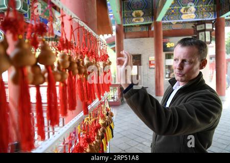 (181123) -- LANZHOU, 23 novembre 2018 -- Stephan Mueller guarda i souvenir in un parco a Lanzhou, capitale della provincia del Gansu della Cina nord-occidentale, 23 ottobre 2018. Stephan, 48 anni, venne in Cina per lavorare come espatriato dalla Germania nel 2006, e 4 anni dopo aveva una propria casa in Cina dopo aver sposato una moglie cinese. Negli anni successivi, viaggiò molto in Cina con sua moglie, fece più amici e imparò di più sulla società cinese. ) (clq) CHINA-LANZHOU-FOREIGNER-LIFE (CN) ChenxBin PUBLICATIONxNOTxINxCHN Foto Stock