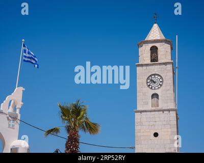 Symi Island, Greece. Greece islands holidays from Rhodos in Aegean Sea. Clock tower on the docks of Symi island. Holiday travel background. Stock Photo