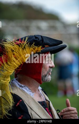 uomo più anziano vestito con abiti o abiti storici tudor del periodo. uomo che indossa un cappello in stile tudor alla riunione di rievocazione. Foto Stock