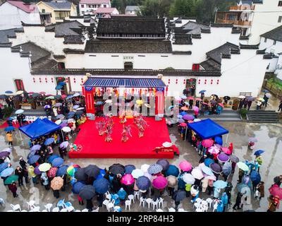 (190217) -- HANGZHOU, 17 febbraio 2019 (Xinhua) -- foto aerea mostra gli abitanti del villaggio che assistono a spettacoli d'opera tradizionali per celebrare l'imminente Chinese Lantern Festival, che cade il 19 febbraio di quest'anno, al villaggio Yaokou di Huyuan Township a Hangzhou, capitale della provincia dello Zhejiang della Cina orientale, il 17 febbraio 2019. Il villaggio di Yaokou è famoso per la sua danza drago con panchina in legno, che ha origine dalla dinastia Qing (1644-1911). Il drago a panchina in legno è lungo 130 metri con 58 panchine in legno collegate tra loro, su cui sono installate varie decorazioni a lanterna. Persone vestite in stile tradizionale Foto Stock