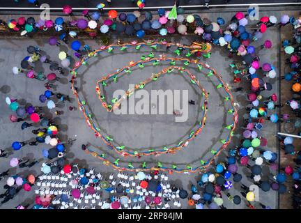 (190217) -- HANGZHOU, 17 febbraio 2019 (Xinhua) -- la foto aerea mostra i membri di una squadra di danza femminile rurale che esegue la danza del drago su panchina di legno per celebrare l'imminente Festival delle Lanterne cinesi, che cade il 19 febbraio di quest'anno, al villaggio Yaokou della città di Huyuan a Hangzhou, capitale della provincia dello Zhejiang della Cina orientale, il 17 febbraio 2019. Il villaggio di Yaokou è famoso per la sua danza drago con panchina in legno, che ha origine dalla dinastia Qing (1644-1911). Il drago a panchina in legno è lungo 130 metri con 58 panchine in legno collegate tra loro, su cui sono installate varie decorazioni a lanterna. Peopl Foto Stock