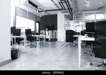 Interni eleganti di un ufficio open space. Area di lavoro con tavoli e sedie Foto Stock