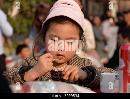 (190324) - HUAI AN, 24 marzo 2019 (Xinhua) -- Una ragazza assaggia i piatti fatti di luosi, una specie di lumaca di fiume, durante una festa che si tiene nella città di Jiangba del distretto di Hongze della città di Huai An, provincia di Jiangsu della Cina orientale, 23 marzo 2019. I piatti di Luosi sono solitamente venduti nelle bancarelle di strada in Cina. (Xinhua/Chen Liang) CHINA-JIANGSU-LUOSI FESTA (CN) PUBLICATIONxNOTxINxCHN Foto Stock