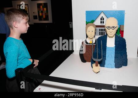 (190324) -- DALLAS, 24 marzo 2019 (Xinhua) -- Un ragazzo guarda un'opera d'arte American Gothic realizzata con mattoni LEGO dall'artista Nathan Sawaya durante la mostra The Art of the Brick a Dallas, Texas, Stati Uniti, il 23 marzo 2019. (Xinhua/Dan Tian) U.S.-DALLAS-ART-EXHIBITION-LEGO PUBLICATIONxNOTxINxCHN Foto Stock