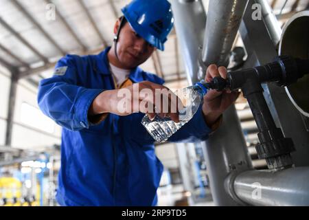 (190416) -- ORDOS, 16 aprile 2019 (Xinhua) -- Un lavoratore mostra le acque reflue dopo il trattamento nella fabbrica di liquefazione del carbone di CHN Energy a Ordos, regione autonoma della Mongolia interna della Cina settentrionale, 11 aprile 2019. (Xinhua/Liu lei) CHINA-INNER MONGOLIA-ORDOS-COAL LIQUEFACTION (CN) PUBLICATIONxNOTxINxCHN Foto Stock