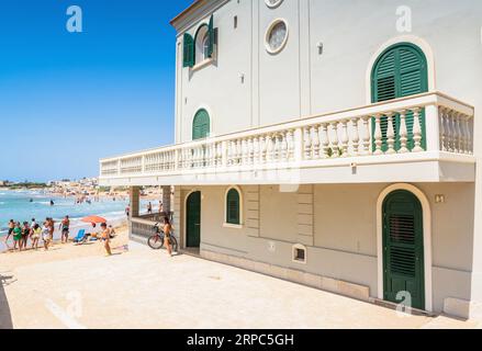 RAGUSA, ITALIA - 21 AGOSTO 2017: Vista sulla spiaggia di Punta secca con i turisti che scattano foto di fronte alla casa dell'ispettore Montalbano a Santa Croce Camerina, Foto Stock